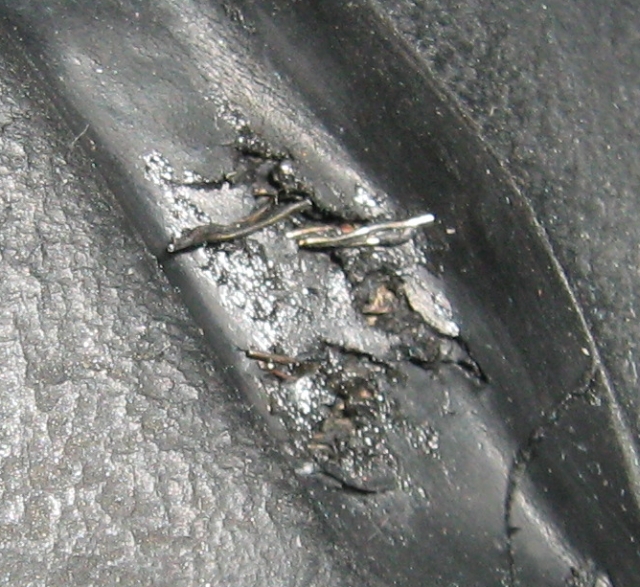 a closeup of the tyre damage on my fazer motorcycle showing the wire threads and broken rubber